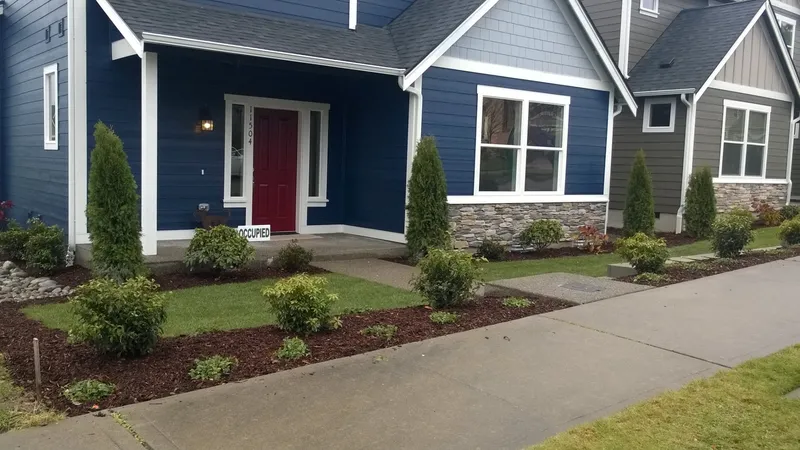 Front-entry foundation plantings and fresh beds on a residential home
